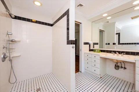 a bathroom with a double sink shower and a mirror