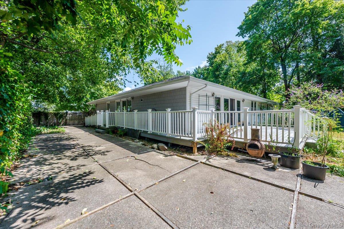 237 Oakwood Road Huntington, NY 11743 - Photo 23 of 29 a backyard of a house with potted plants and large tree