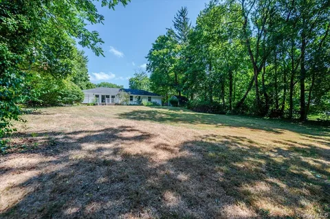 a view of a yard with a tree