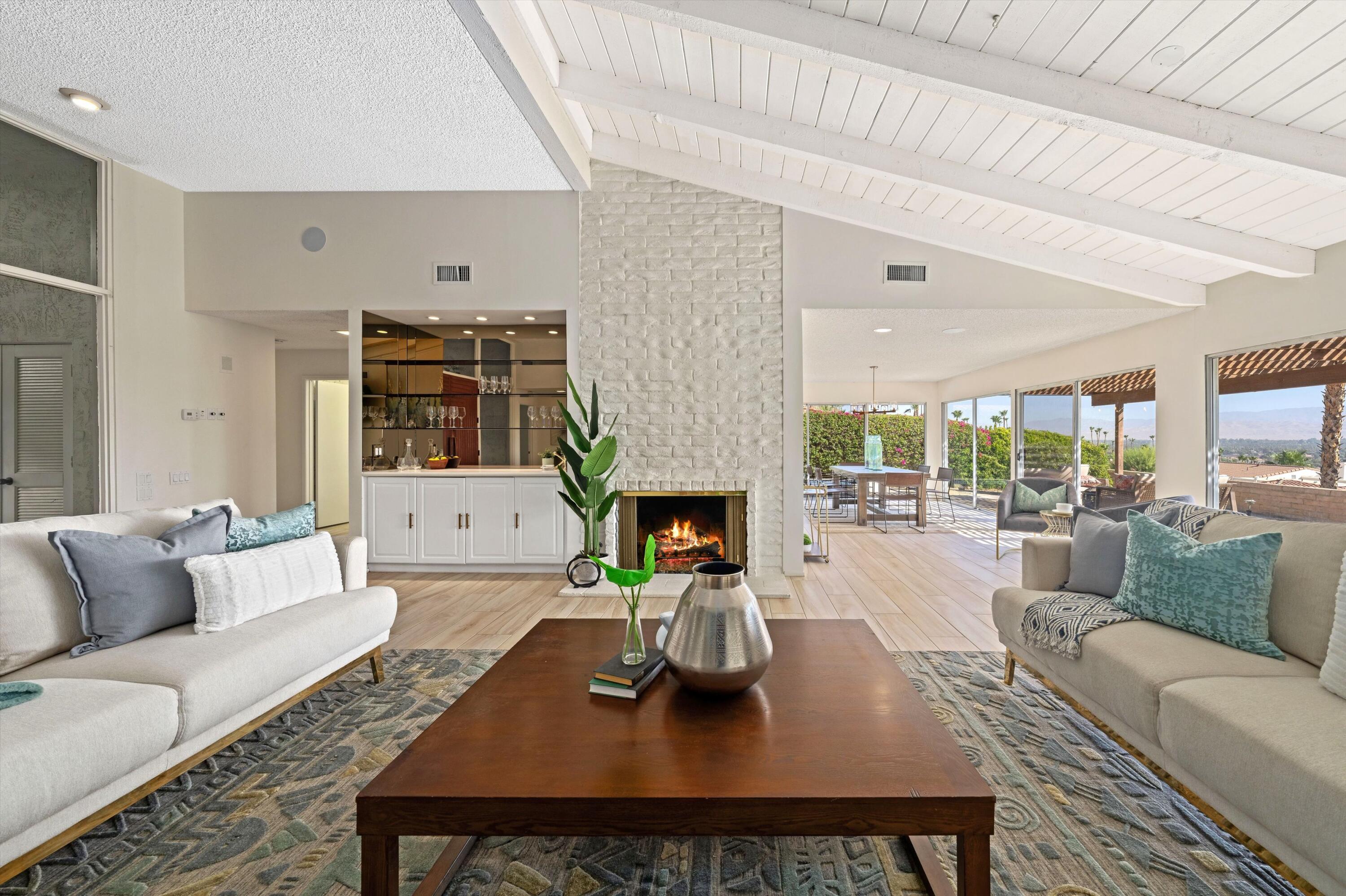40270 Paseo Del Rey Rancho Mirage, CA 92270 - Photo 12 of 41 a living room with furniture a rug and a fireplace