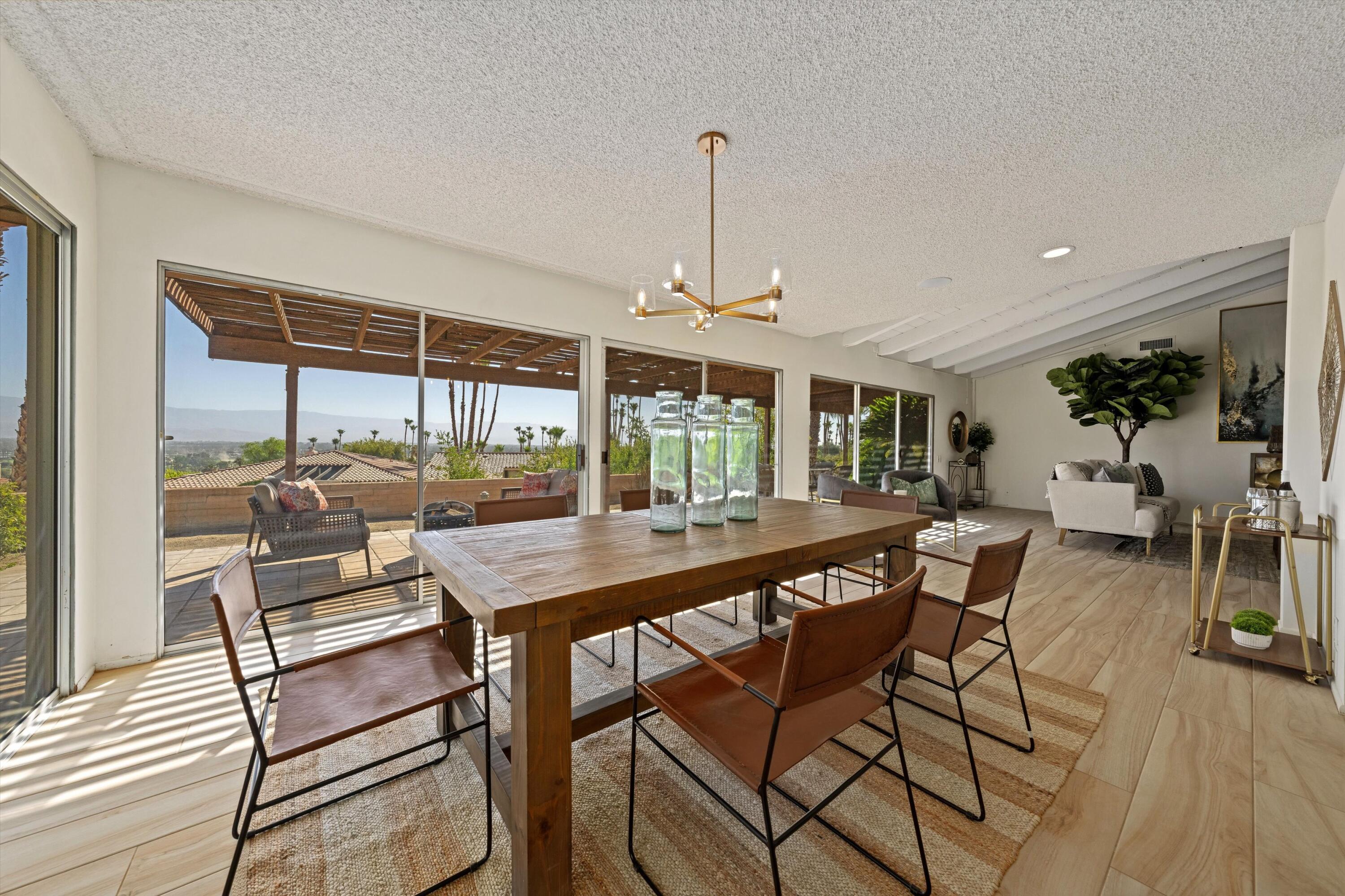 40270 Paseo Del Rey Rancho Mirage, CA 92270 - Photo 15 of 41 a view of a dining room with furniture wooden floor and chandelier