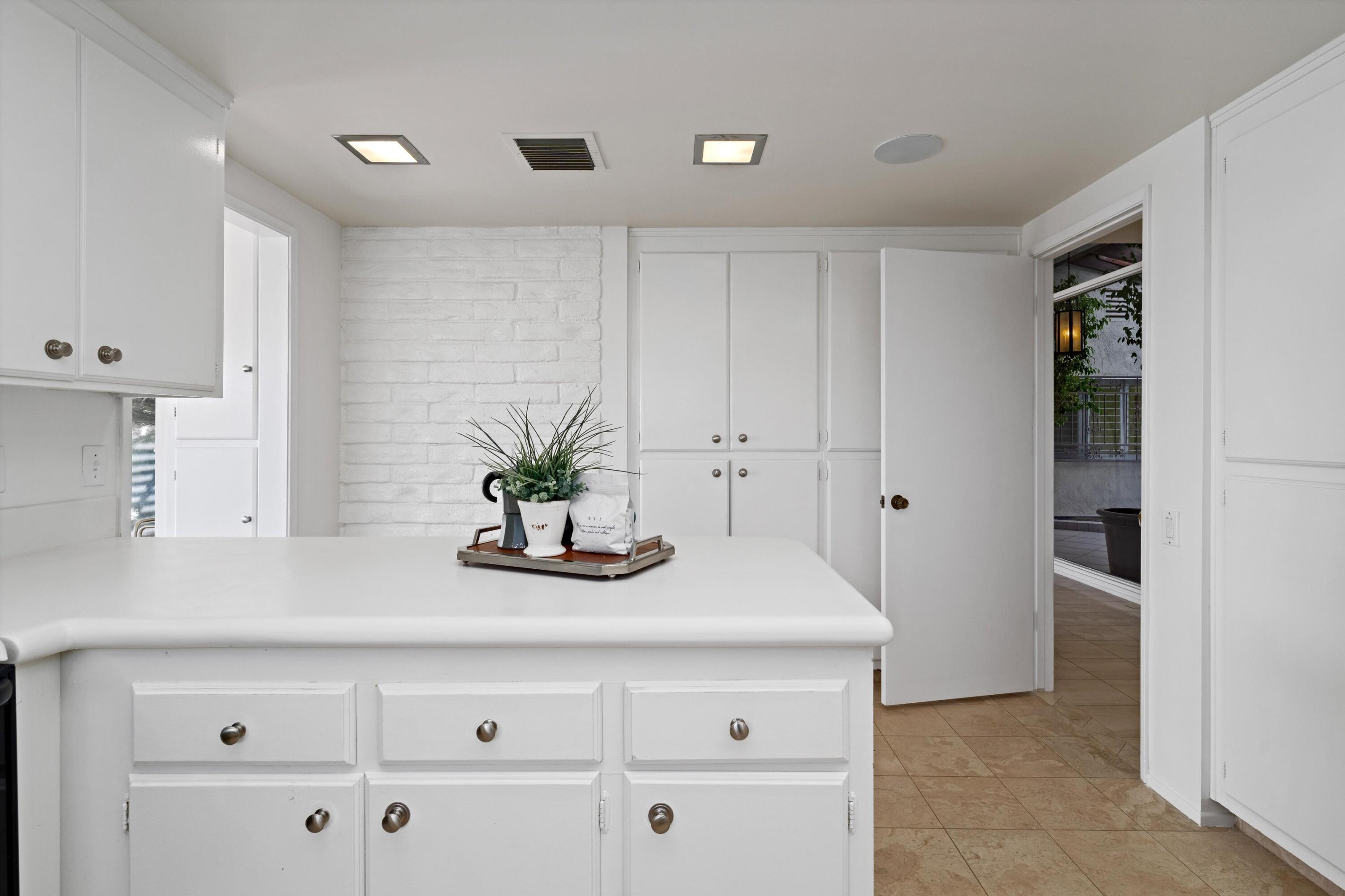 40270 Paseo Del Rey Rancho Mirage, CA 92270 - Photo 20 of 41 a bathroom with a sink a potted plant and a window