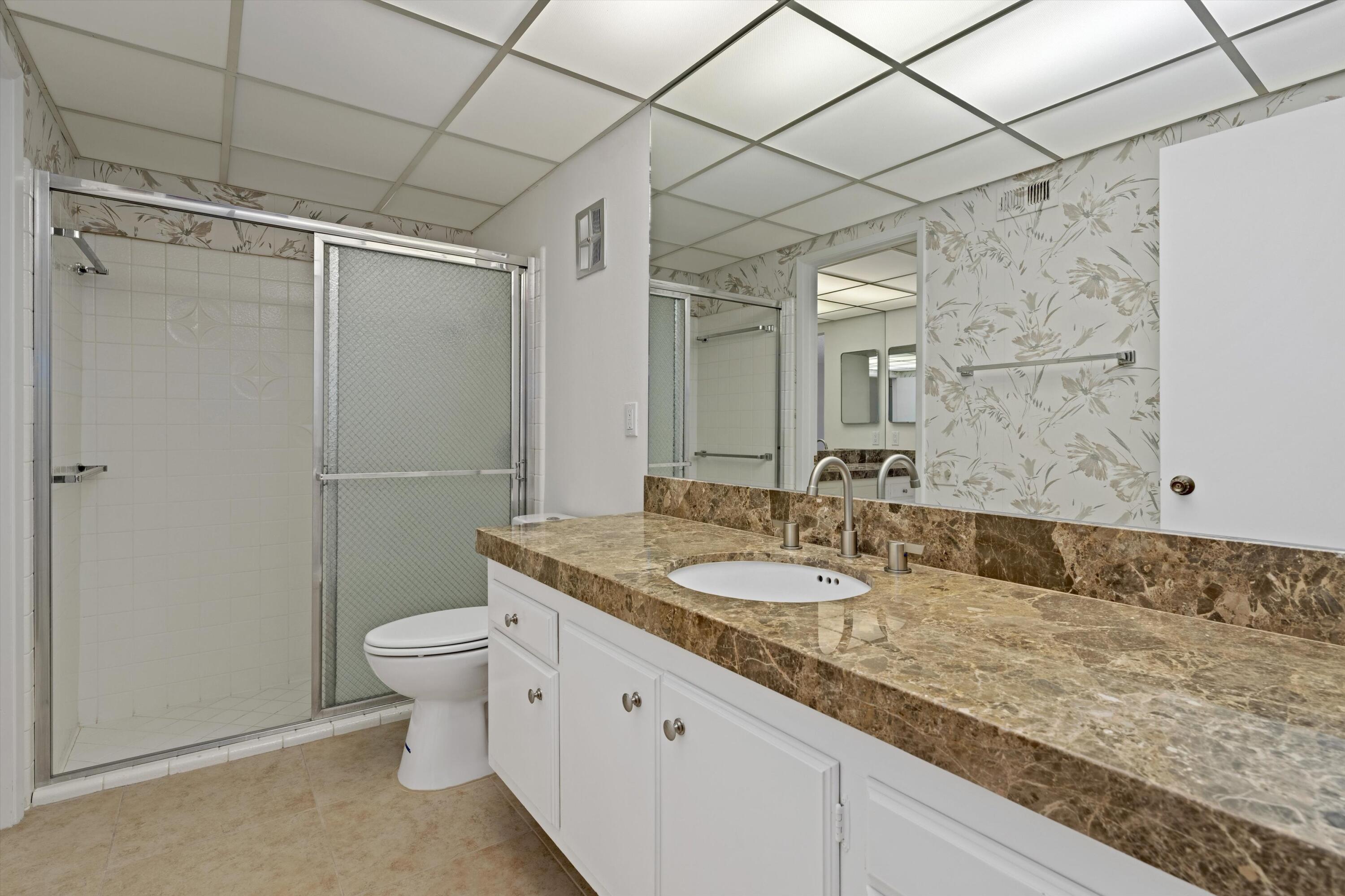 40270 Paseo Del Rey Rancho Mirage, CA 92270 - Photo 27 of 41 a bathroom with a granite countertop sink mirror vanity and toilet