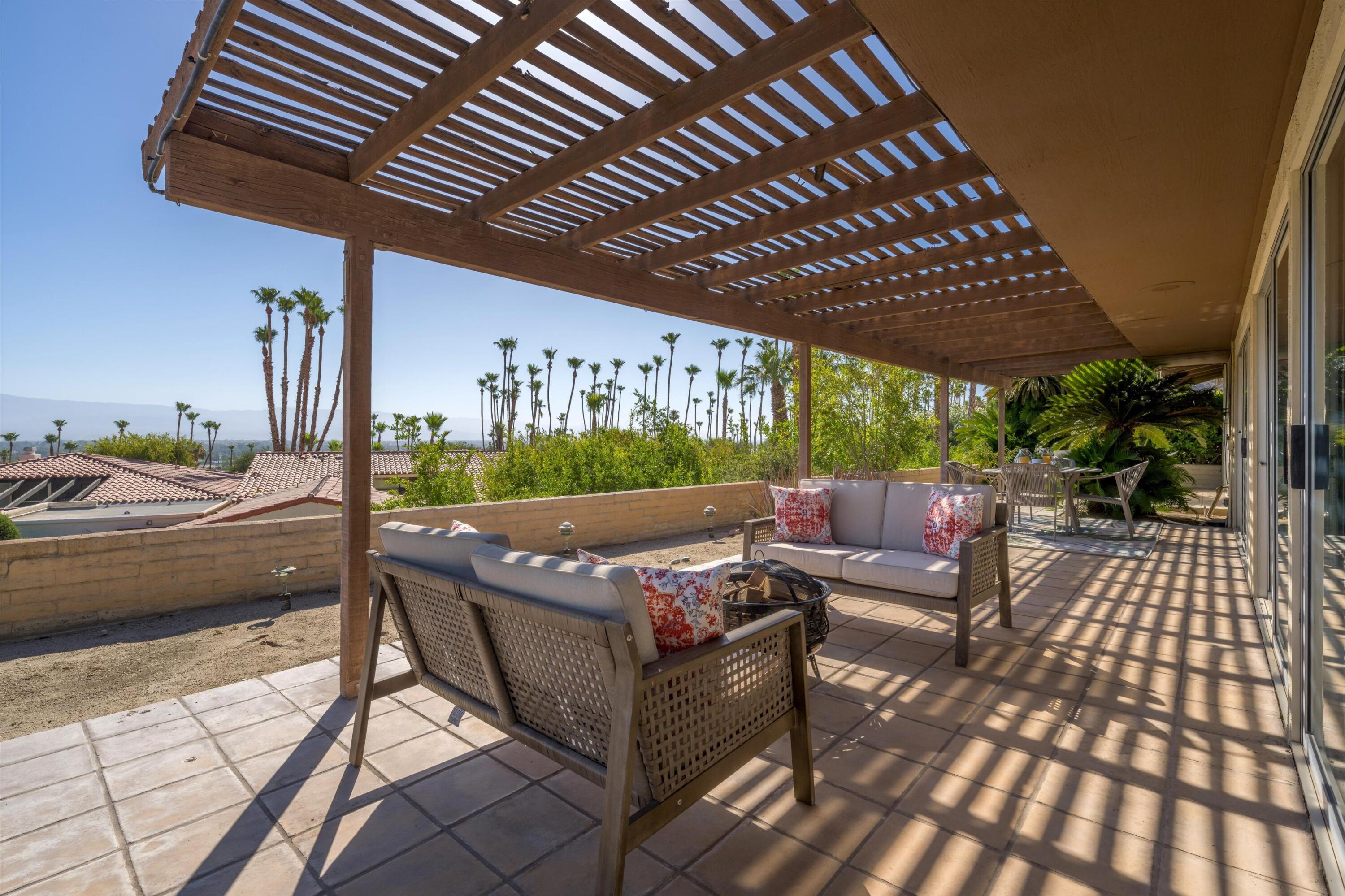 40270 Paseo Del Rey Rancho Mirage, CA 92270 - Photo 39 of 41 a view of a patio with table and chairs barbeque potted plants and large tree