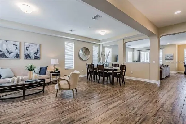 a view of a dining room with furniture window and wooden floor