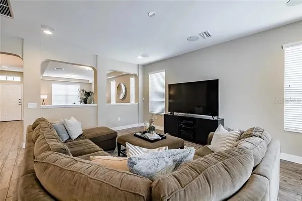 a bedroom with a bed and lamp on the dresser