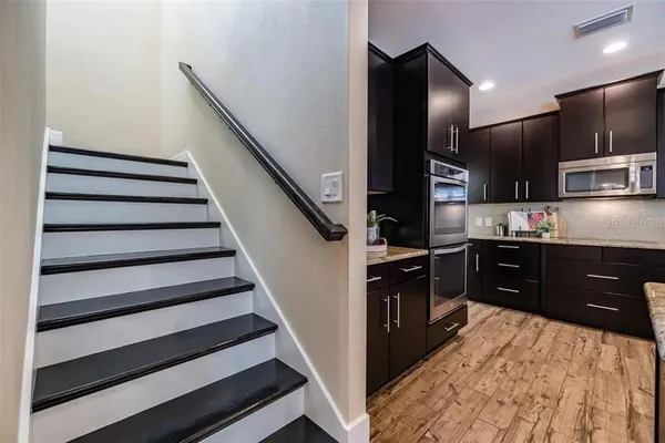 a bathroom with a granite countertop tub sink and mirror