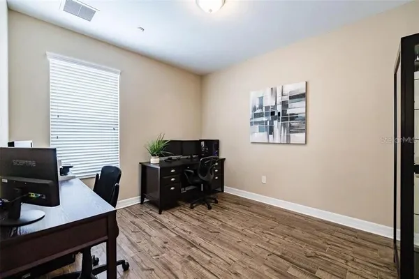 a spacious bedroom with a bed and a cabinets