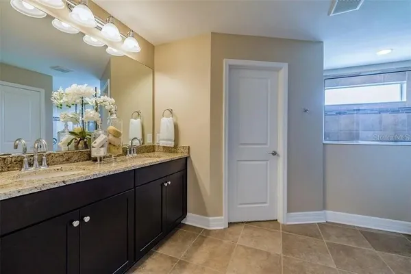 a open kitchen with stainless steel appliances kitchen island granite countertop a table and chairs in it