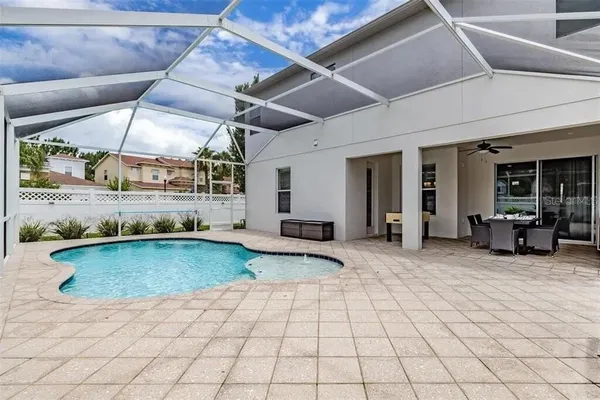 a view of a tennis ground with large trees