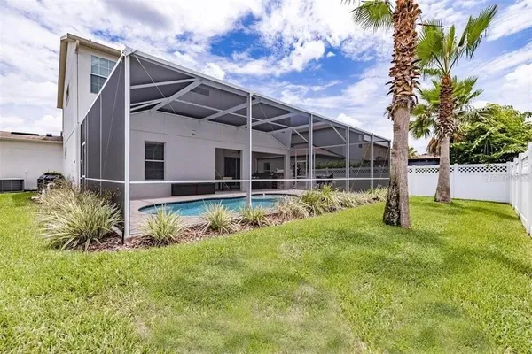 a living room with furniture and large windows