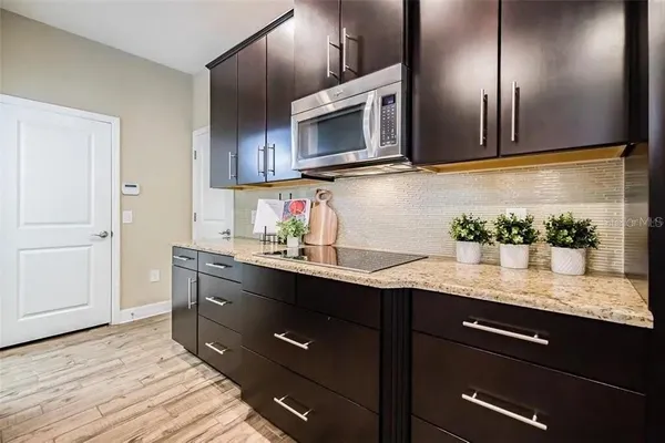 a kitchen with cabinets and stainless steel appliances