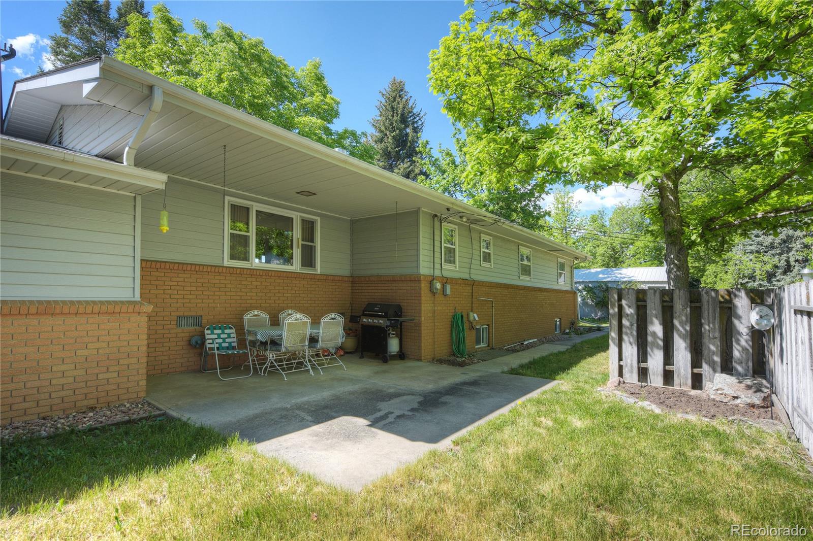 4405 Agate Road Boulder, CO 80304 - Photo 31 of 40 a backyard of a house with yard and outdoor seating