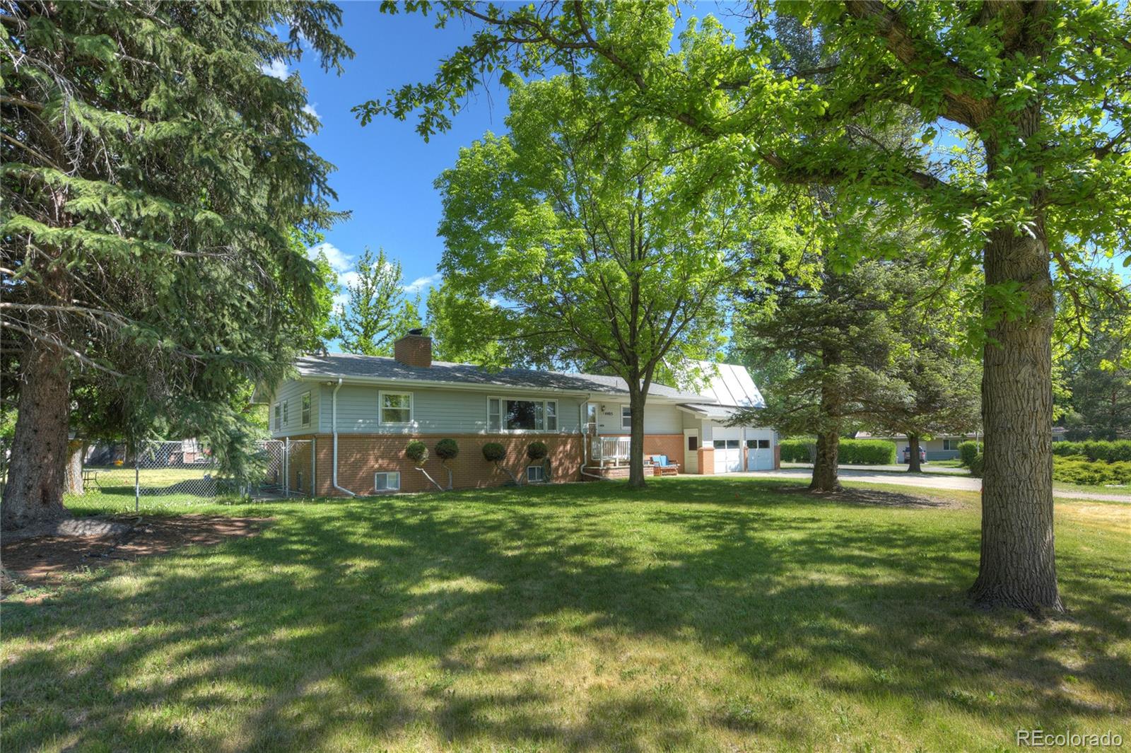 4405 Agate Road Boulder, CO 80304 - Photo 4 of 40 a view of a house with a big yard and large trees