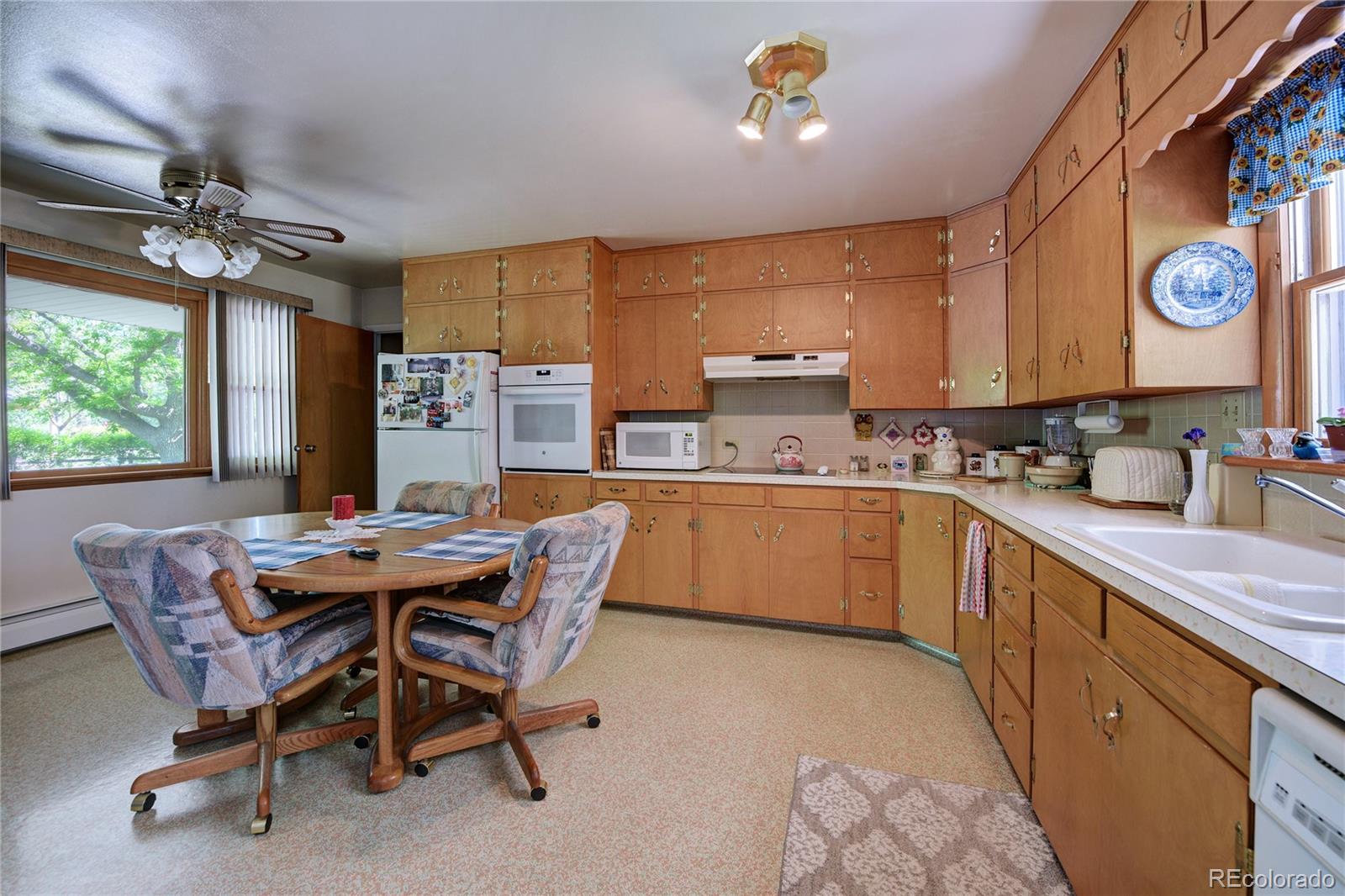 4405 Agate Road Boulder, CO 80304 - Photo 6 of 40 a kitchen with a table chairs sink and cabinets