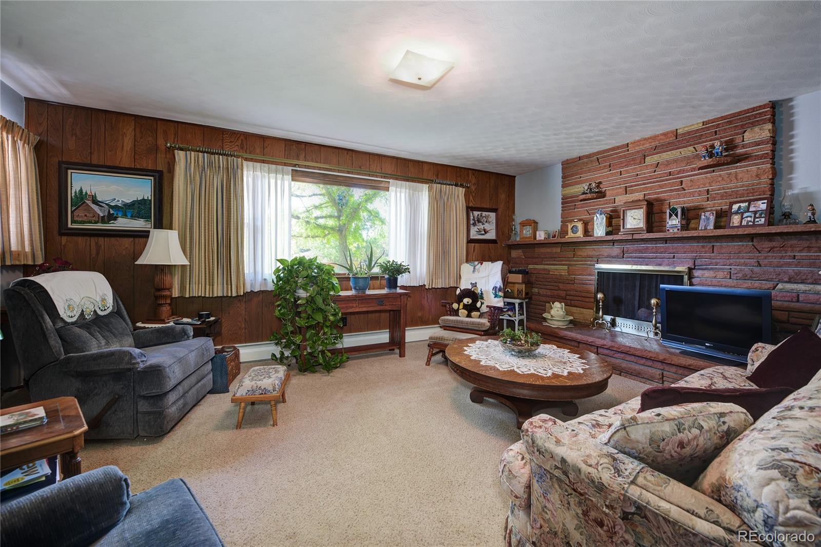 4405 Agate Road Boulder, CO 80304 - Photo 10 of 40 a living room with furniture a fireplace and a window