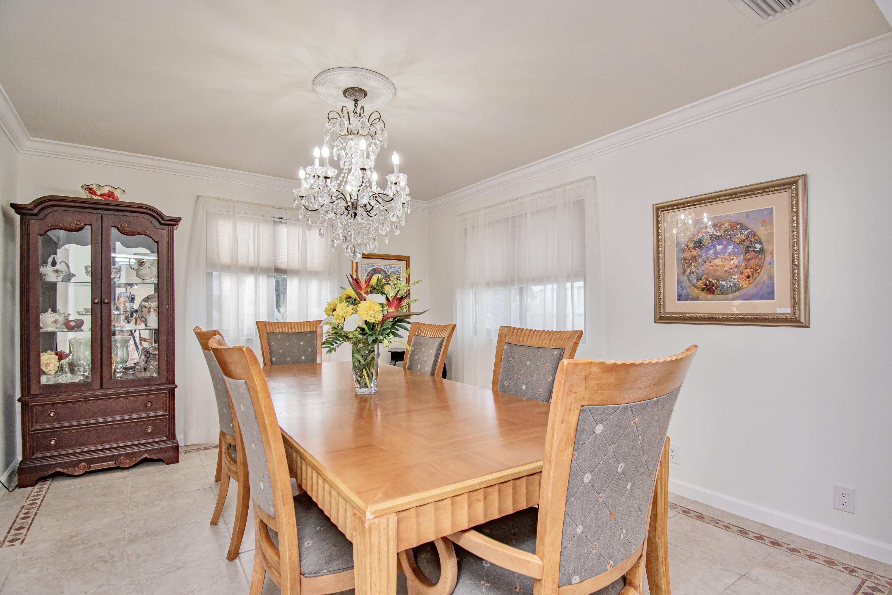 7838 Cypress Crescent Boca Raton, FL 33433 - Photo 8 of 24 a dining room with furniture and chandelier
