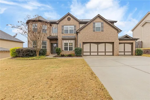 a front view of a house with a yard