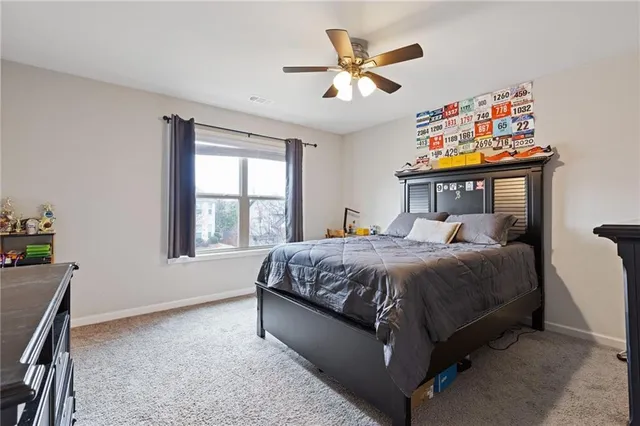 a spacious bedroom with a bed and a window