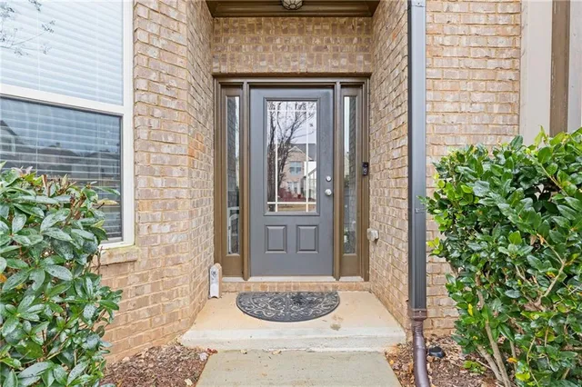a front view of a house with potted plants