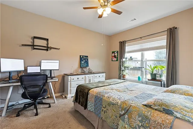 a bedroom with a bed and a desk