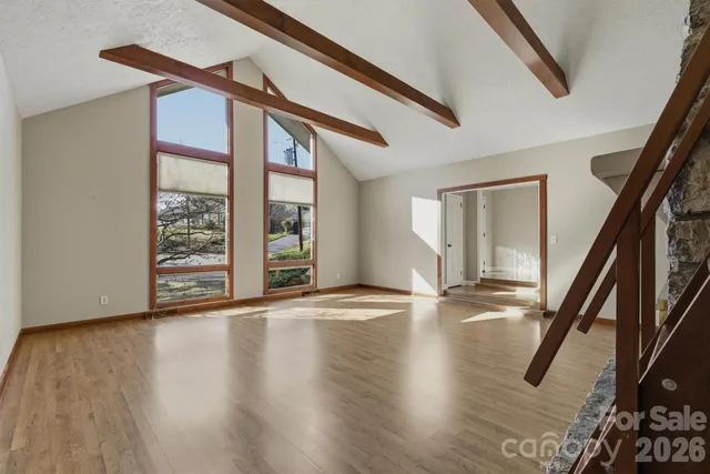 a view of an entryway with wooden floor and door