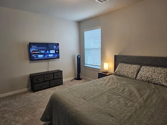 a bedroom with a bed and a window