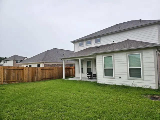 a front view of house with yard and outdoor seating