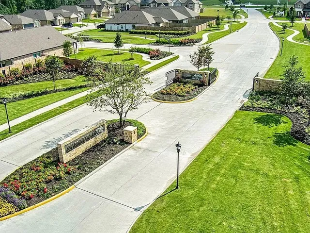 a view of a swimming pool with a yard and potted plants