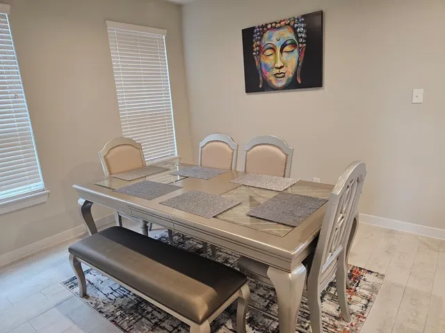 a table with chairs and a rug
