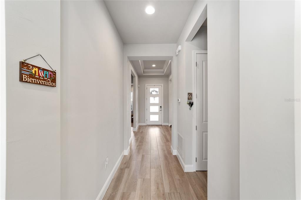 11895 Southwest 33 Lane Gainesville, FL 32608 - Photo 14 of 67 a view of a hallway with wooden floor and a bathroom