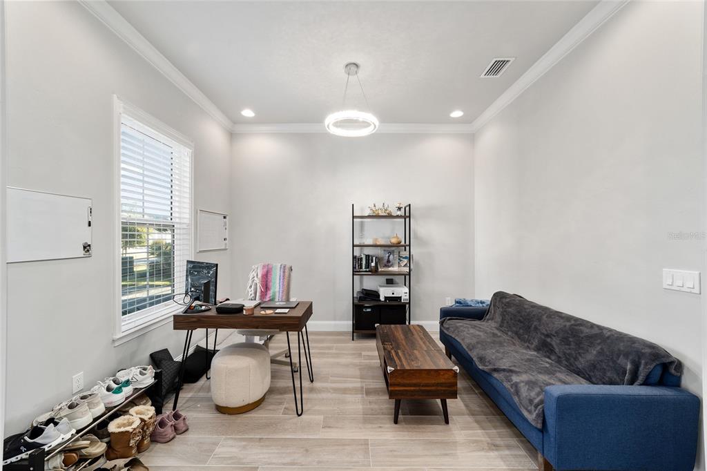 11895 Southwest 33 Lane Gainesville, FL 32608 - Photo 16 of 67 a living room with furniture and wooden floor