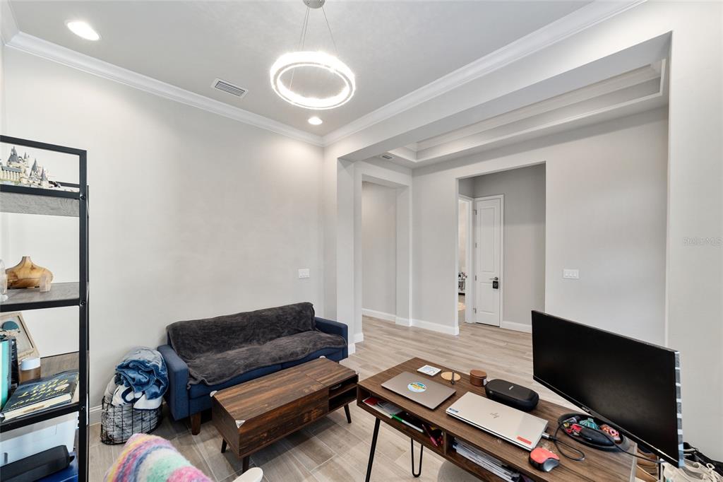 11895 Southwest 33 Lane Gainesville, FL 32608 - Photo 17 of 67 a living room with furniture and a flat screen tv