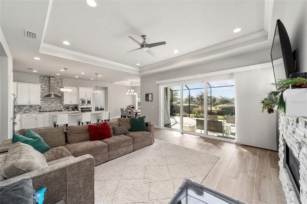 11895 Southwest 33 Lane Gainesville, FL 32608 - Photo 20 of 67 a living room with furniture floor to ceiling window and wooden floor