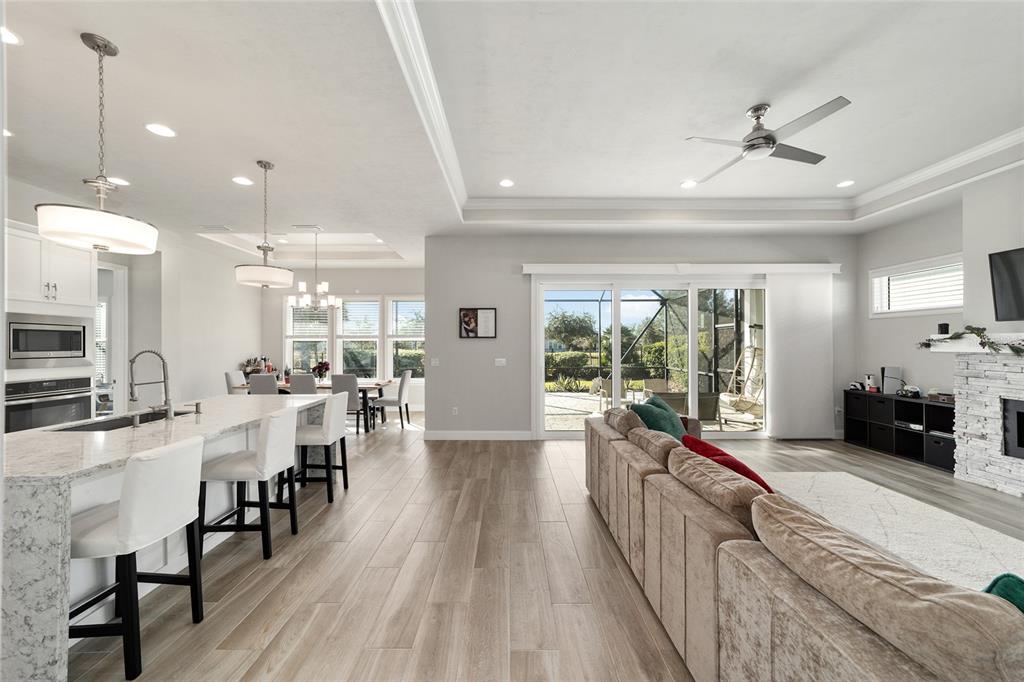 11895 Southwest 33 Lane Gainesville, FL 32608 - Photo 22 of 67 a large open kitchen with a large window and stainless steel appliances