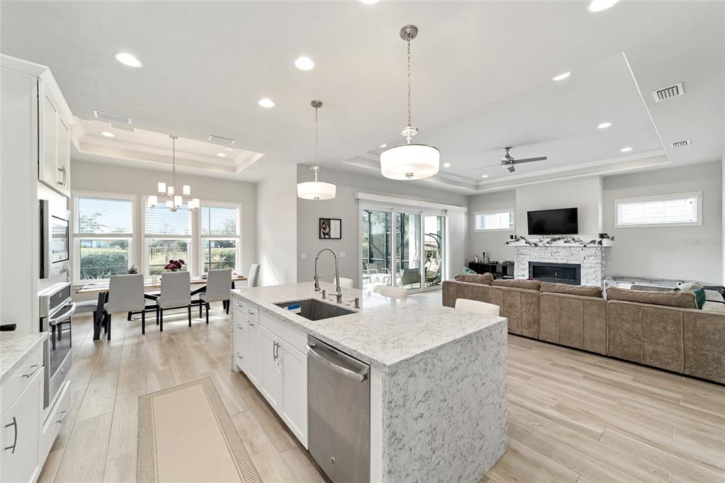 11895 Southwest 33 Lane Gainesville, FL 32608 - Photo 23 of 67 a large white kitchen with lots of counter space and furniture