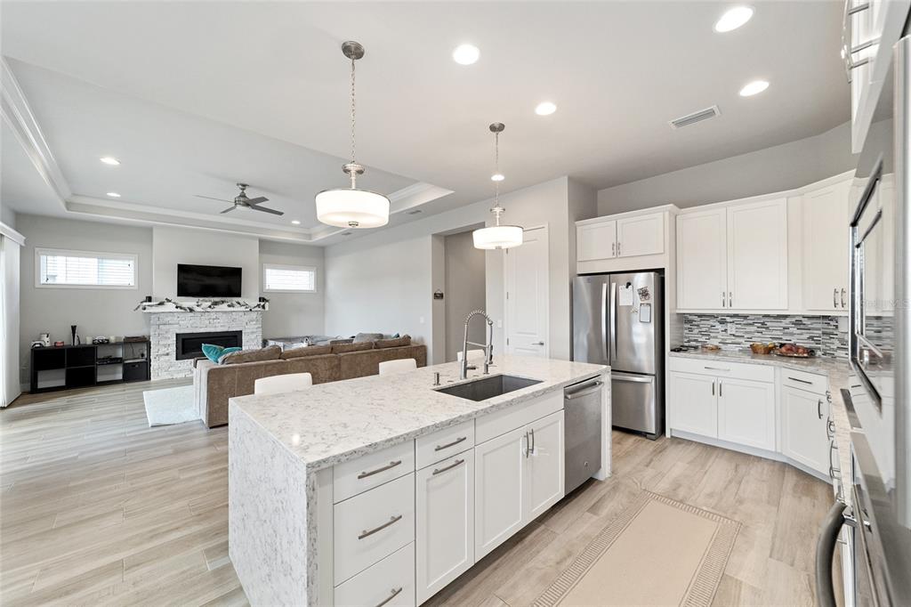 11895 Southwest 33 Lane Gainesville, FL 32608 - Photo 25 of 67 a kitchen with a sink stove and refrigerator