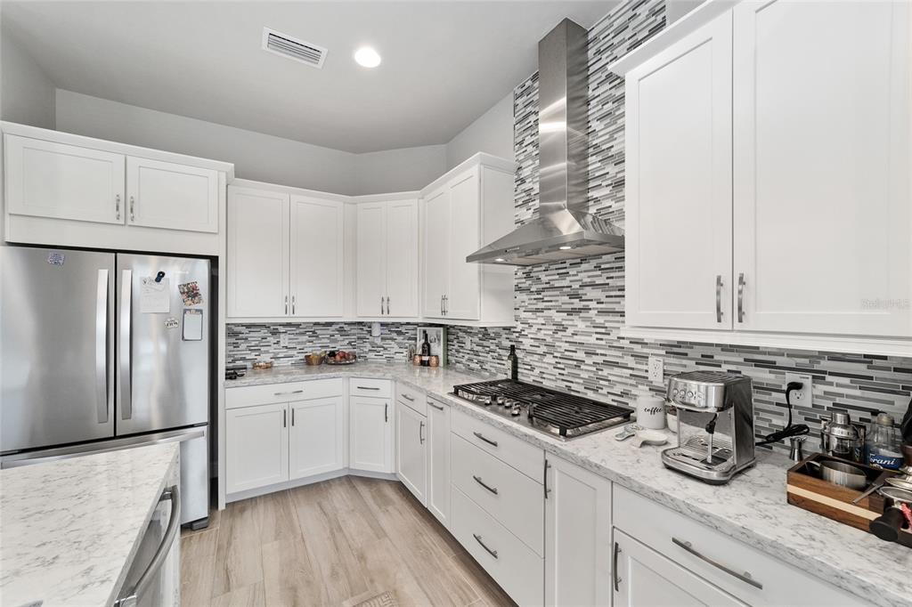 11895 Southwest 33 Lane Gainesville, FL 32608 - Photo 29 of 67 a kitchen with a sink a stove and refrigerator