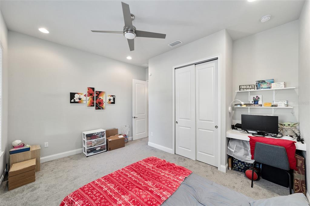 11895 Southwest 33 Lane Gainesville, FL 32608 - Photo 40 of 67 a bedroom with furniture and a fan