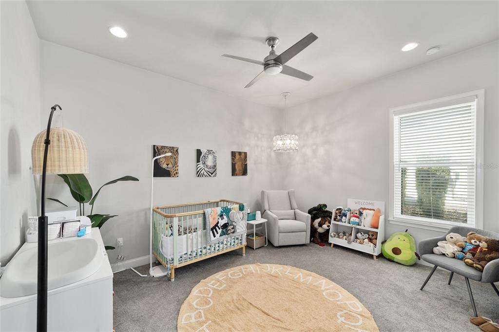 11895 Southwest 33 Lane Gainesville, FL 32608 - Photo 42 of 67 a spacious bedroom with a bed a couch and a window