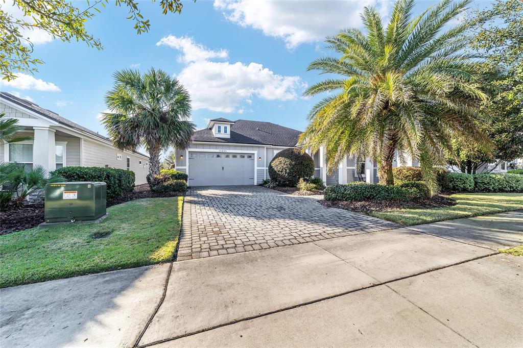 11895 Southwest 33 Lane Gainesville, FL 32608 - Photo 8 of 67 a view of a house with a yard and coconut trees