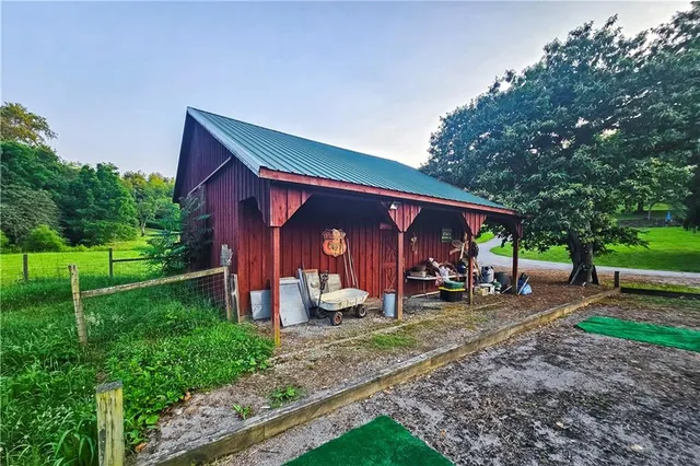 a view of a house with a backyard and sitting area