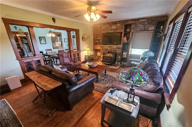 a living room with furniture a chandelier and a dining table