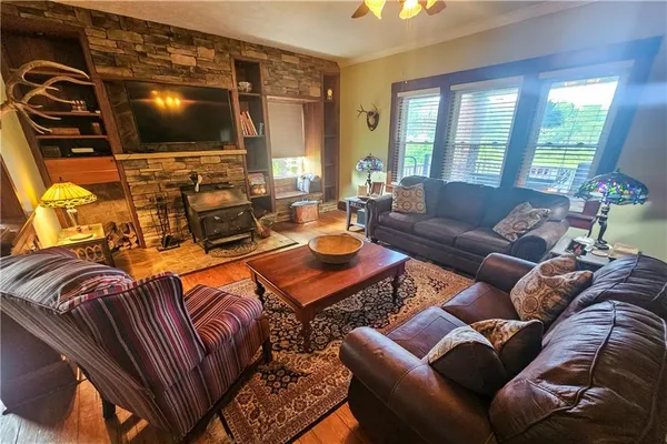 a living room with furniture a flat screen tv and a large window