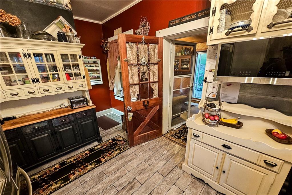 221 Mc Caughtry Run Road Darlington, PA 16115 - Photo 6 of 50 a blue kitchen with stainless steel appliances a stove and a microwave