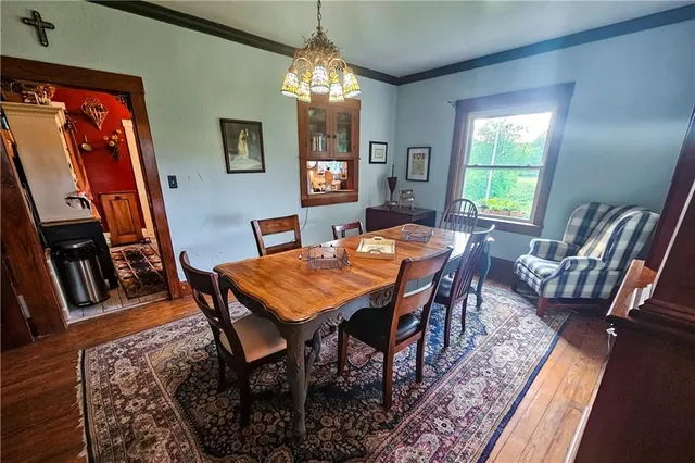 a dining room with furniture a rug and wooden floor