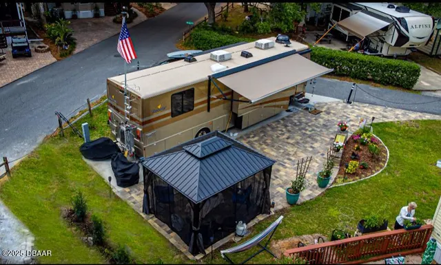 an aerial view of a house with a yard patio and outdoor seating