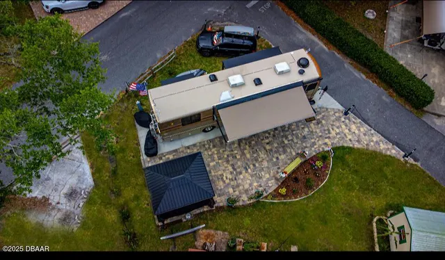 an aerial view of a house with a yard