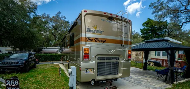 a view of a chairs and tables in the back yard of the house