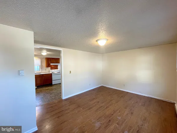 a view of a room with wooden floor and a sink